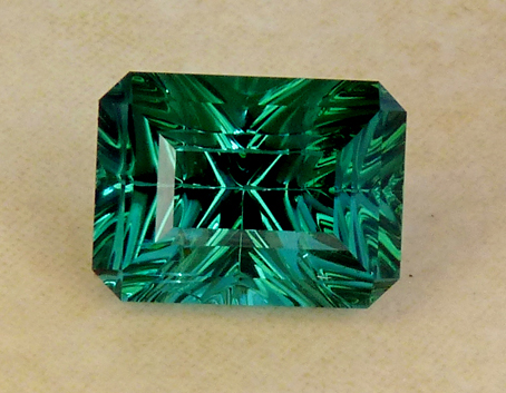 greenish-blue to blue concave faceted tourmaline