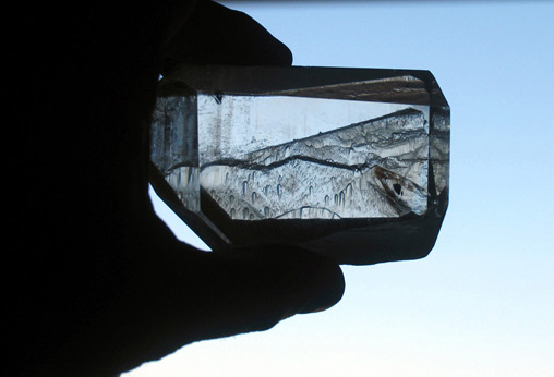 unusual etched quartz crystal with a scenic landscape